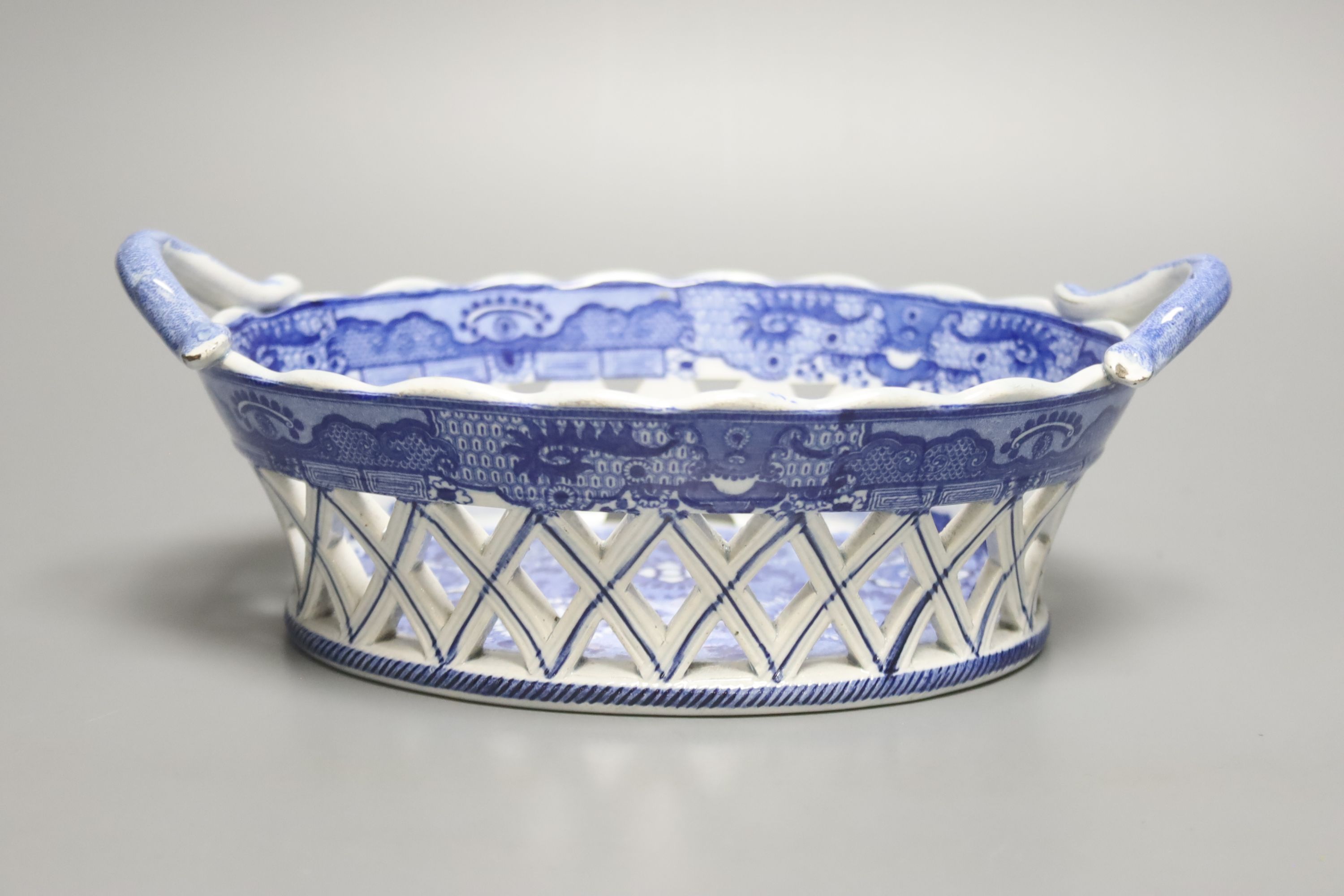 An English pottery basket printed in under glaze blue with stylised motifs probably Spode, length 23.5cm